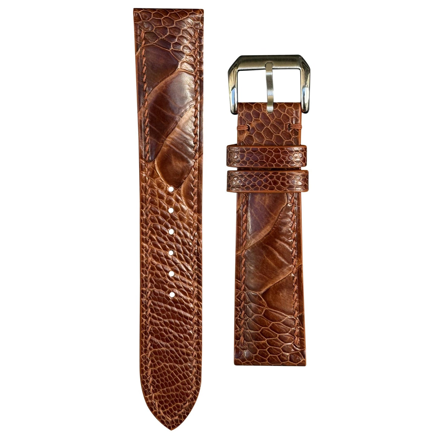 Rooibos Tea ostrich leg leather watch strap with brown stitching and silver buckle, flat lay.