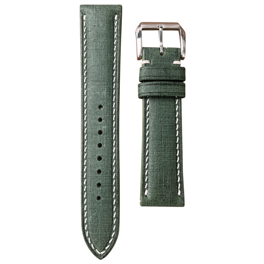 Verde Babele linen leather watch strap with white stitching and a polished silver buckle, flat lay.
