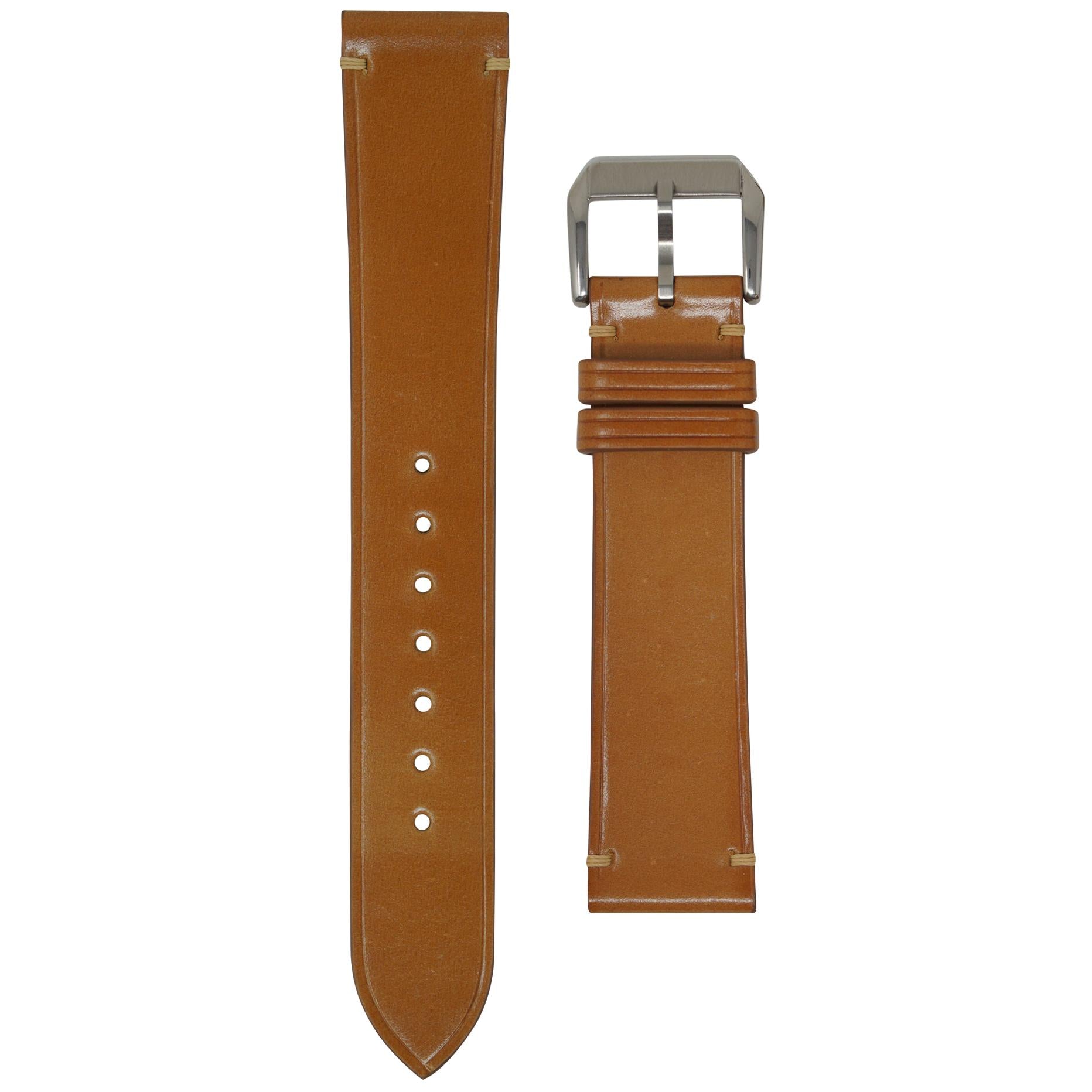 Natural Shell Cordovan leather watch strap with light stitching and a silver buckle, flat lay.