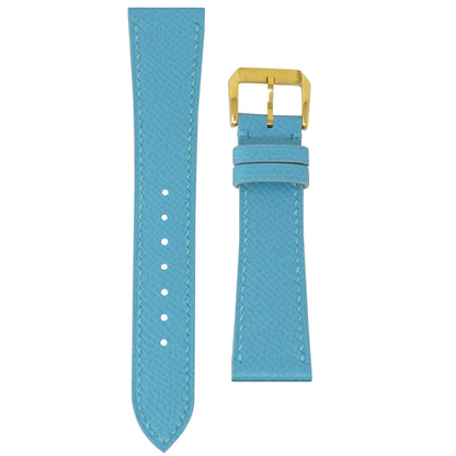 Baby blue Epsom leather watch strap with matching stitching and a gold buckle, flat lay.