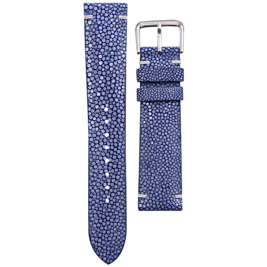 Blue stingray leather watch strap with white stitching and silver buckle, flat lay.