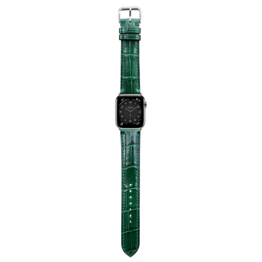 Green crocodile leather watch strap for Apple Watch, flat lay.