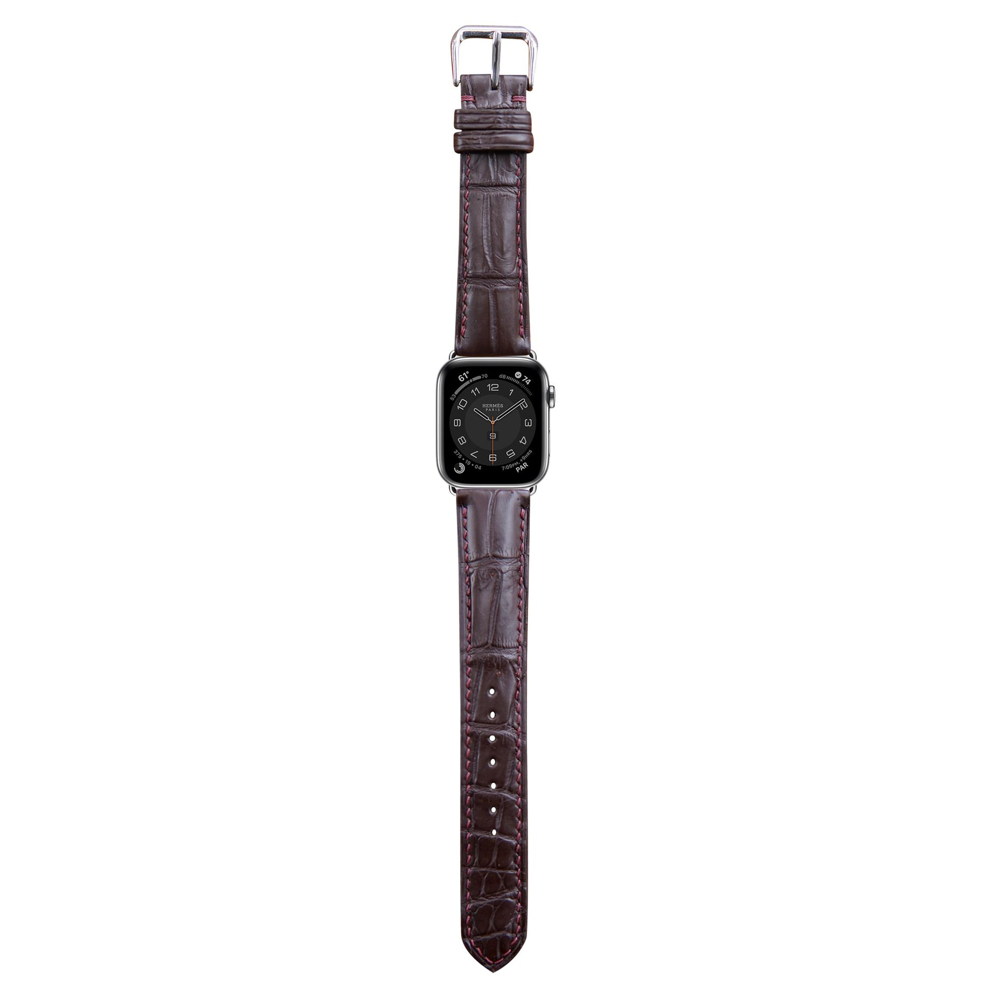 Brown crocodile leather watch strap with red stitching and silver buckle, flat lay.