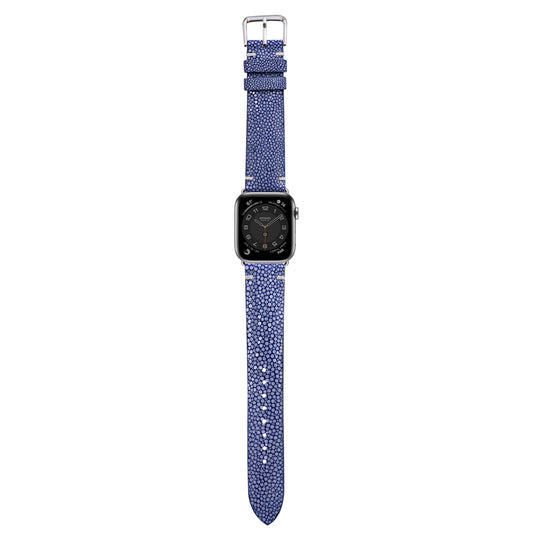 Blue stingray leather watch strap with silver buckle, attached to an Apple Watch, flat lay.