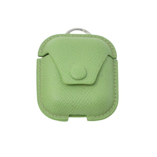Green Epsom leather Airpods case with matching stitching and a silver keyring, front view.