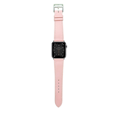 Pink Swift leather watch strap with white stitching and silver buckle, flat lay.