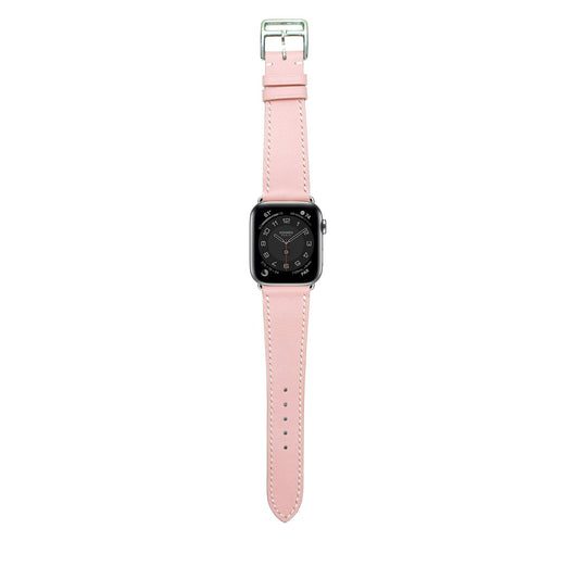 Pink Swift leather watch strap with white stitching and silver buckle, flat lay.