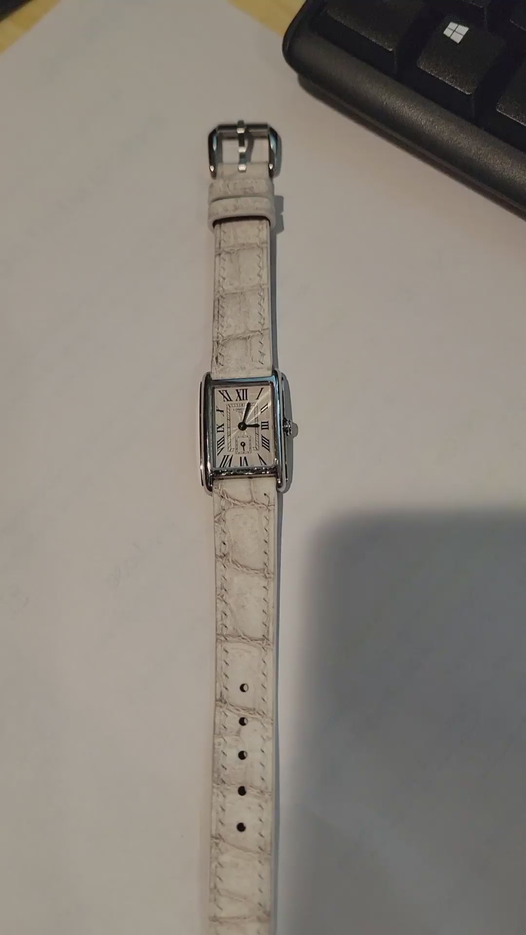 Customer demonstration of a sand white crocodile leather watch strap showing the full watch, front, reverse, lining and buckle.