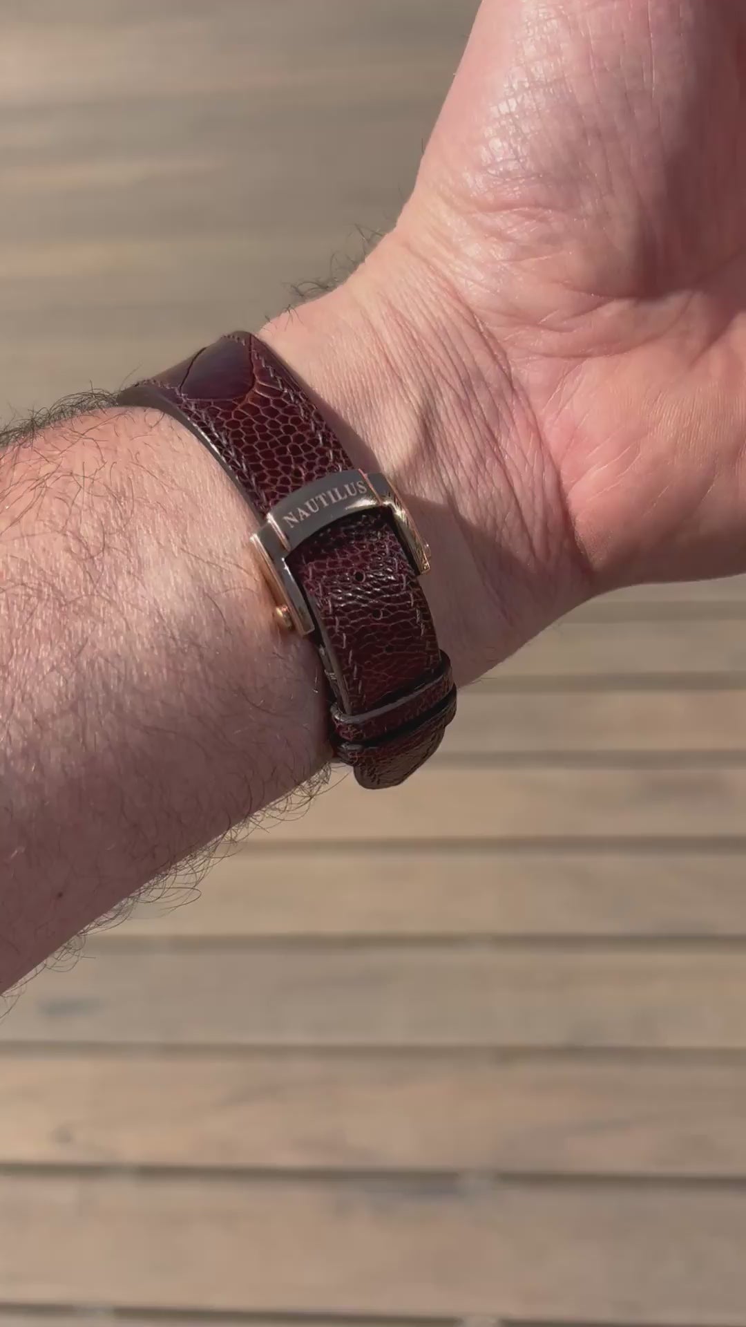 Customer video showing a burgundy custom centre-notched leather watch strap fitted to a Nautilus-style watch.