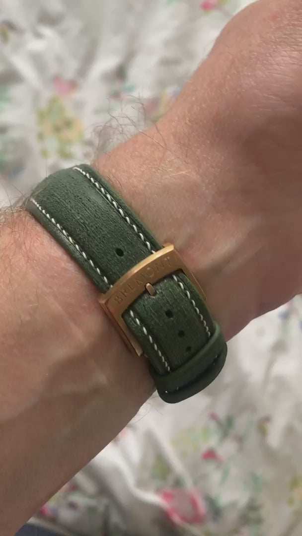 Green Verde Linen custom curved-end leather watch strap fitted to a bronze watch, shown from front and buckle-side customer video views.