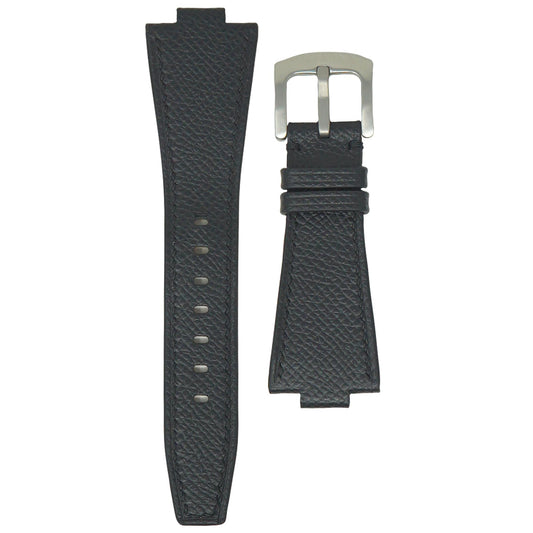 Black textured leather watch strap with silver buckle, flat lay.