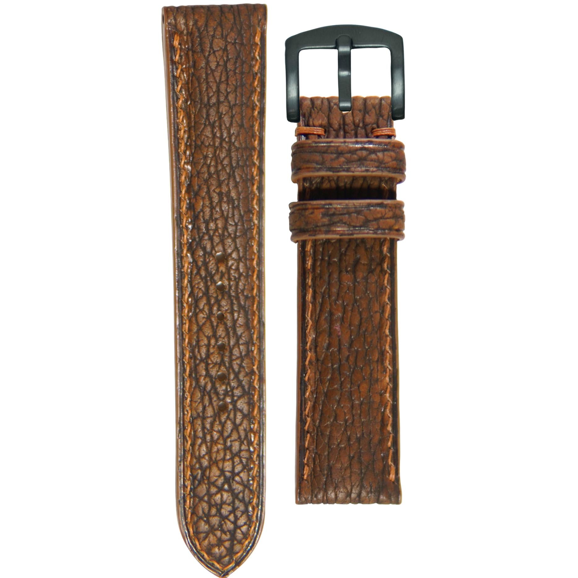 Brown shark skin leather watch strap with brown stitching and black buckle, flat lay.
