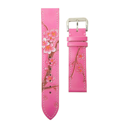 Pink leather watch strap with hand-painted sakura blossoms and white stitching, flat lay.