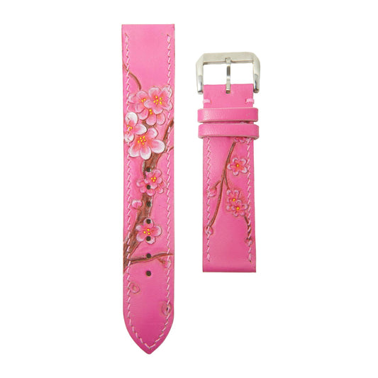 Pink leather watch strap with hand-painted sakura blossoms and white stitching, flat lay.