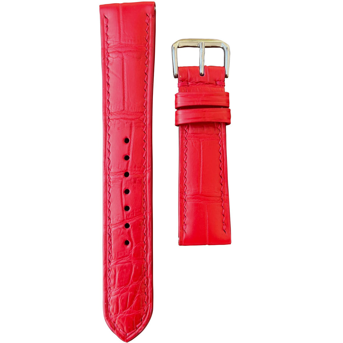 Red crocodile leather watch strap with silver buckle, flat lay.