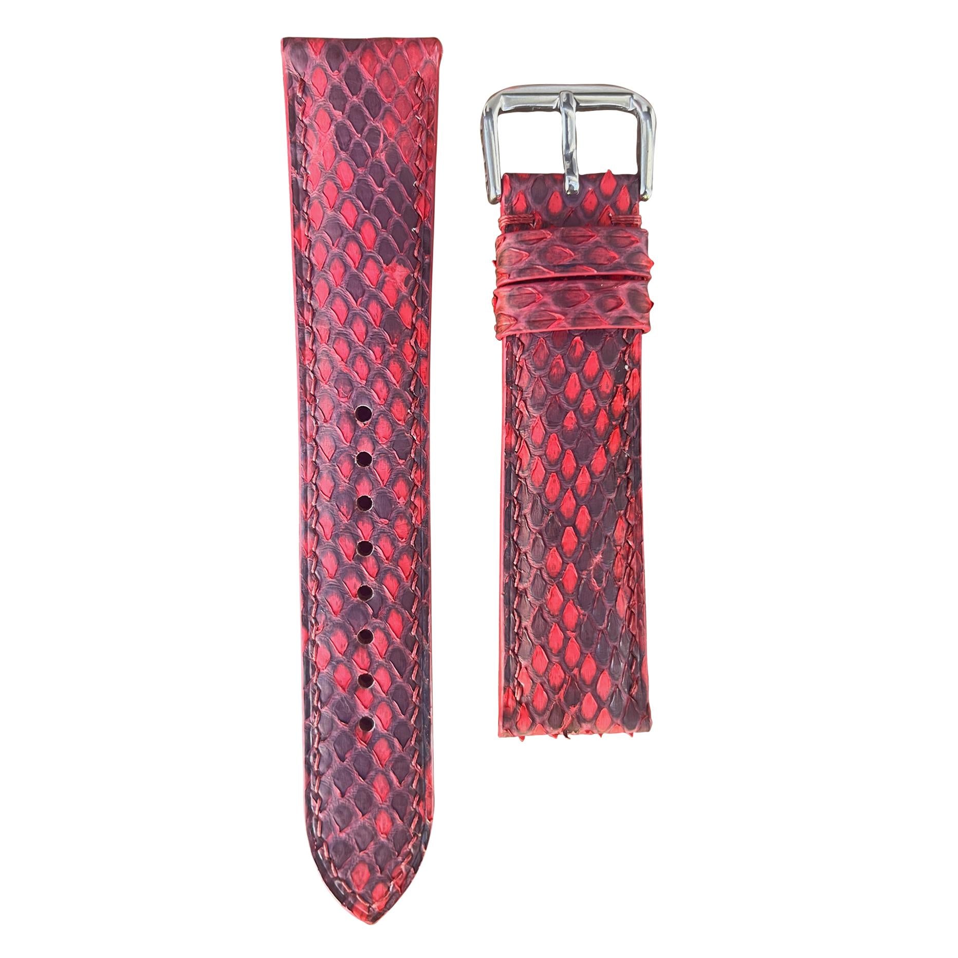 Red snake skin leather watch strap with silver buckle, flat lay.