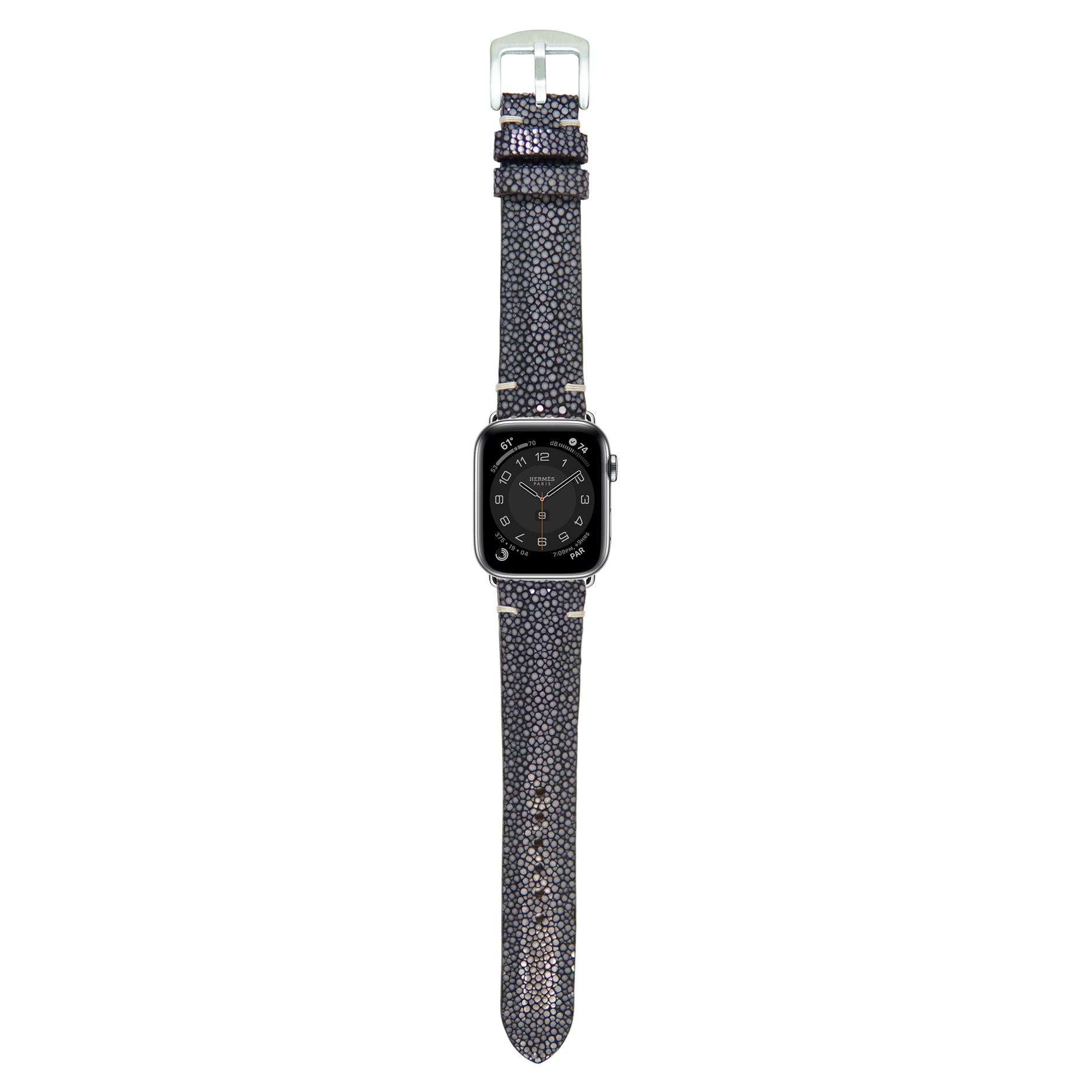 Black stingray leather watch strap with light stitching and silver buckle, flat lay.