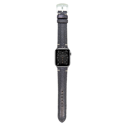 Black stingray leather watch strap with light stitching and silver buckle, flat lay.
