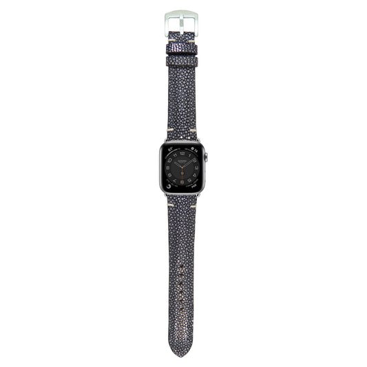 Black stingray leather watch strap with light stitching and silver buckle, flat lay.