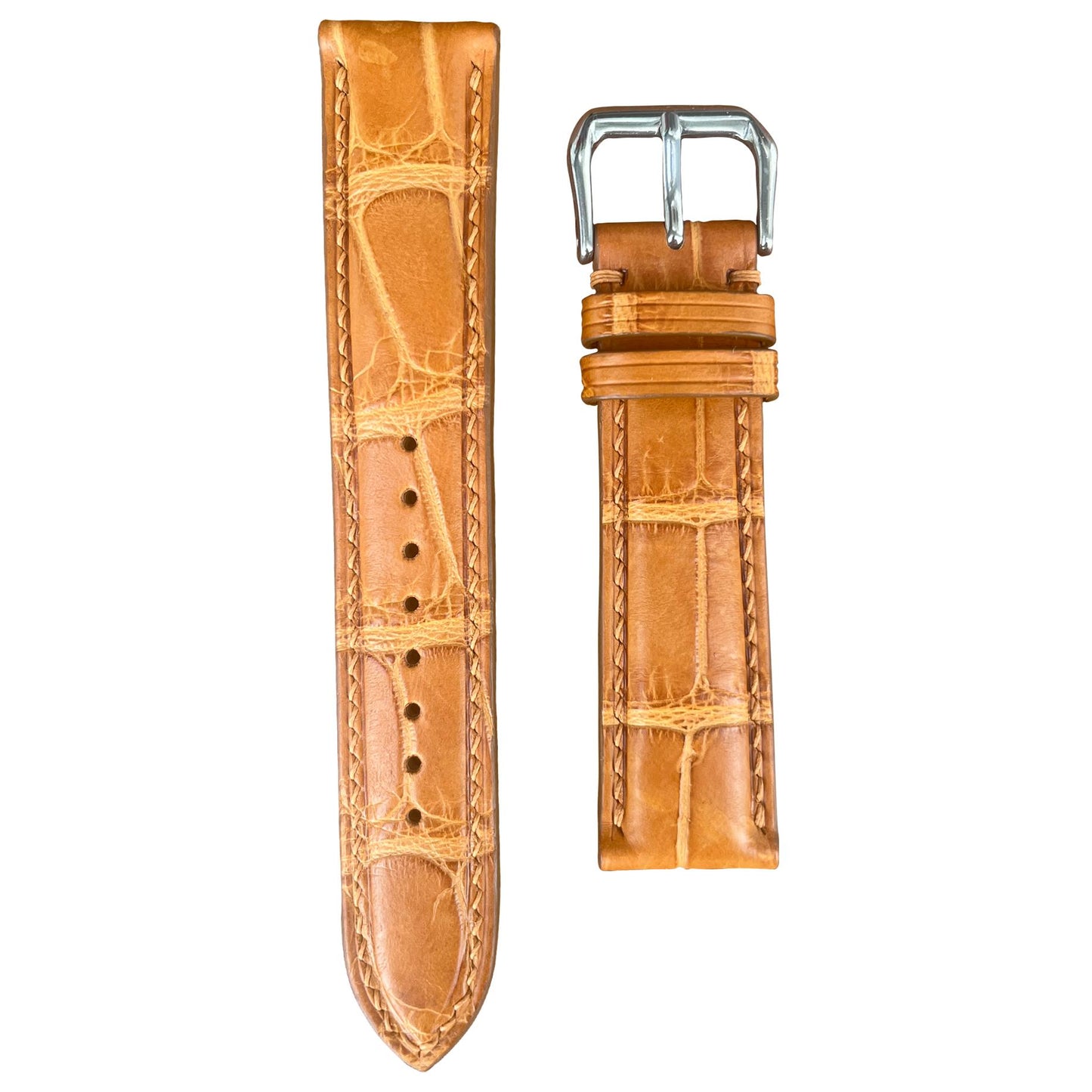 Light brown crocodile leather watch strap with matching stitching and silver buckle, flat lay.