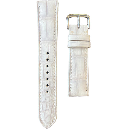 Sand white crocodile leather watch strap with white stitching and silver buckle, flat lay.