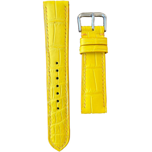 Yellow crocodile leather watch strap with matching stitching and silver buckle, flat lay.